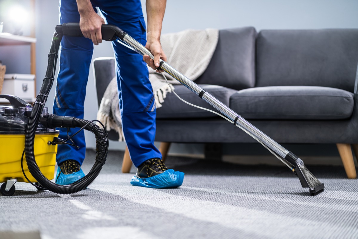 person cleaning carpet with vacuum cleaner picture id1191080465